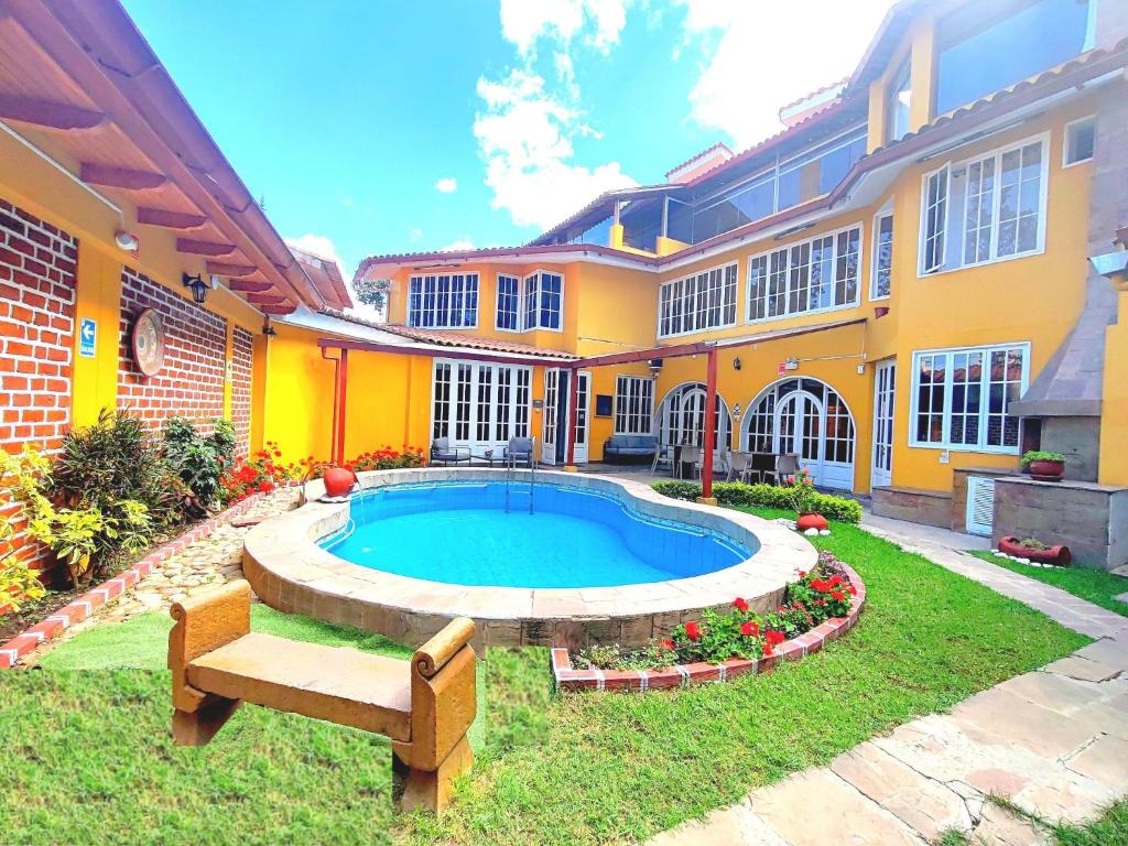 a house with a swimming pool in the yard at Hotel Serra Nova in Cajamarca