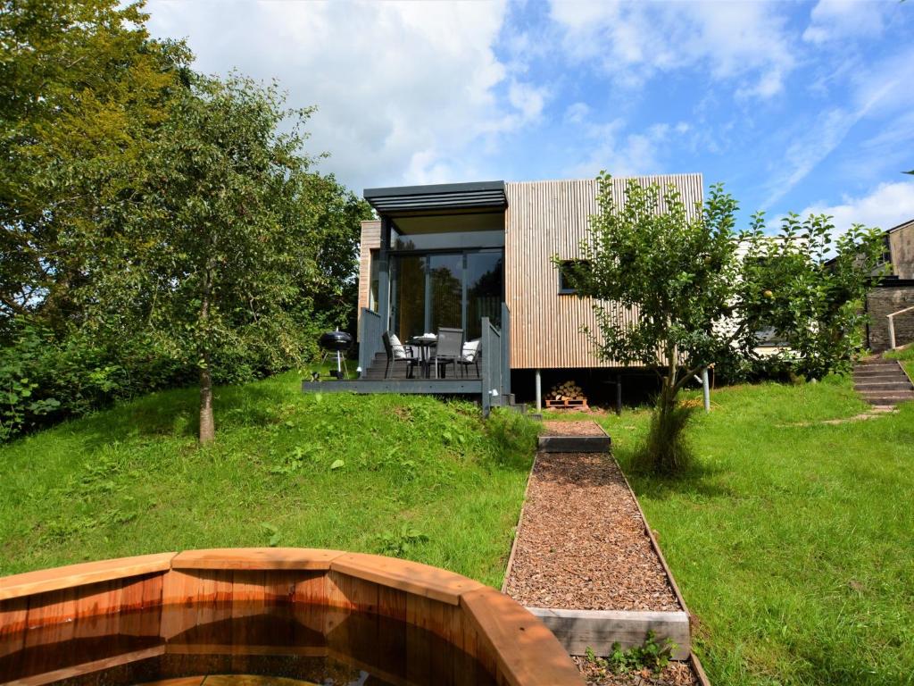 a house on a hill with a pond in the yard at 2 Bed in Brecon 59734 in Talgarth