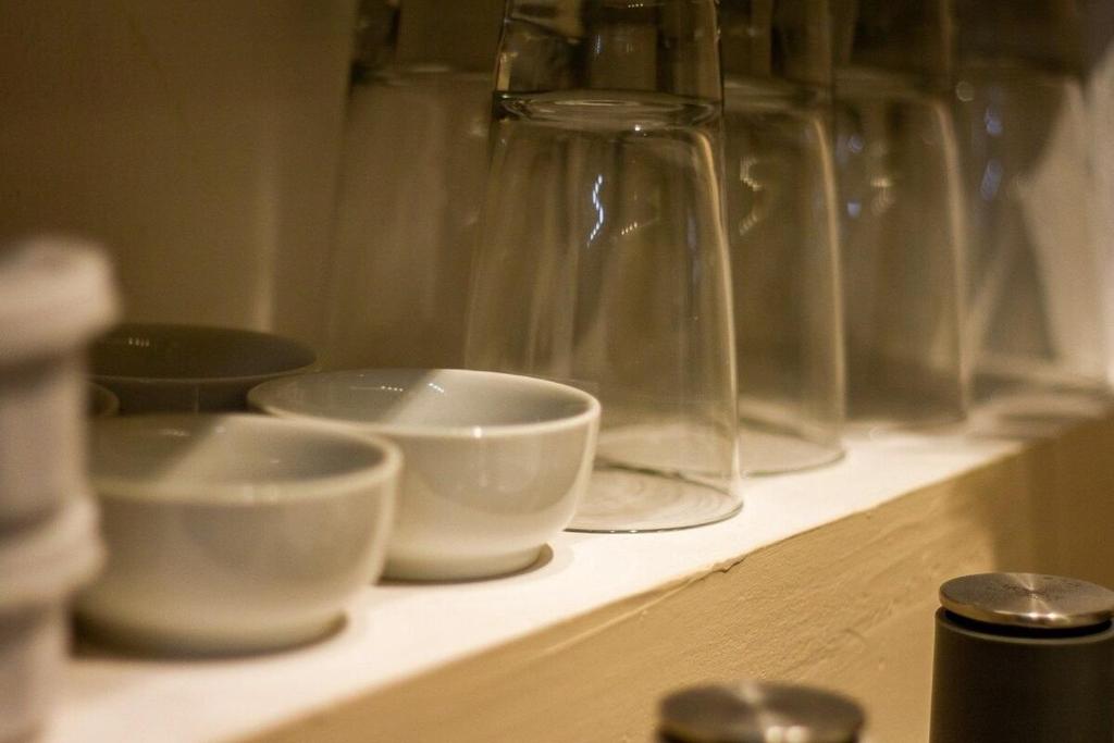 a shelf with bowls and glass vases on it at Ro Prime. Stylish & Comfortable With Jacuzzi & A/C in Guadalajara