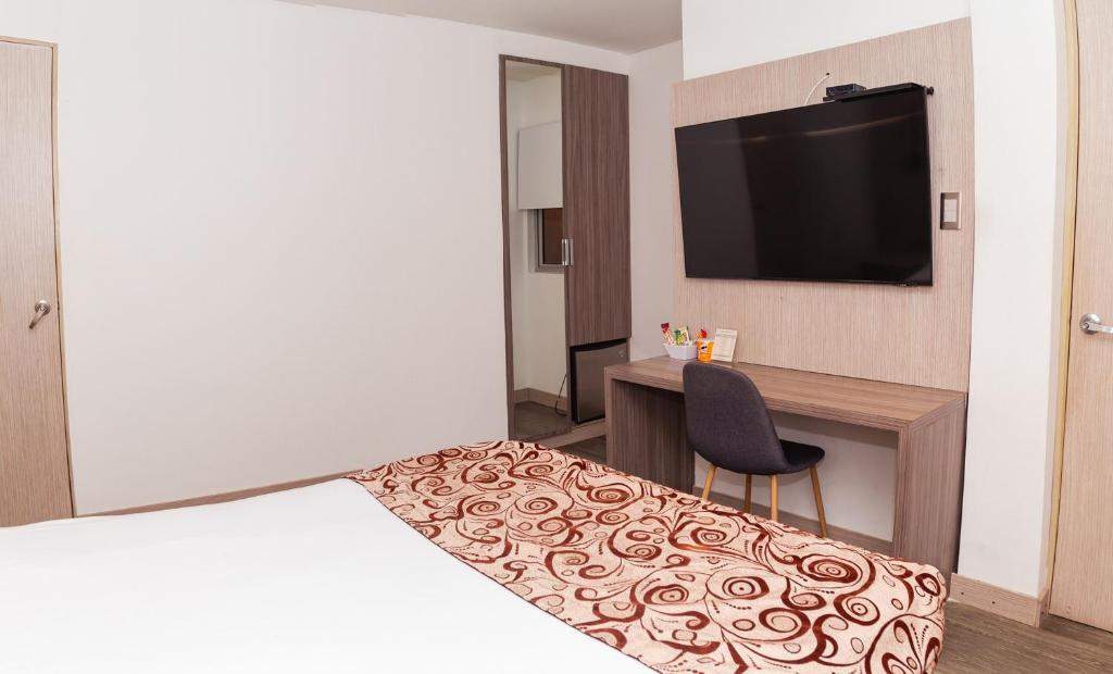 Postel nebo postele na pokoji v ubytování Hotel Laureles Loft
