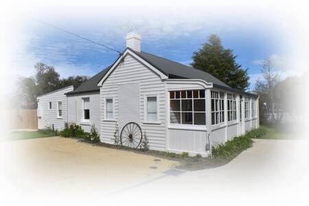 a rendering of a white house with a window at The Baker's Cottage in the Heart of Richmond Sleeps 6 in Hobart