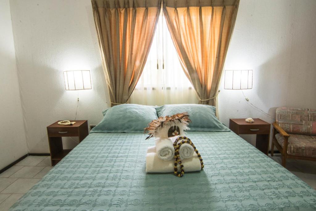 Postel nebo postele na pokoji v ubytování Hotel Hotu Matua by EI