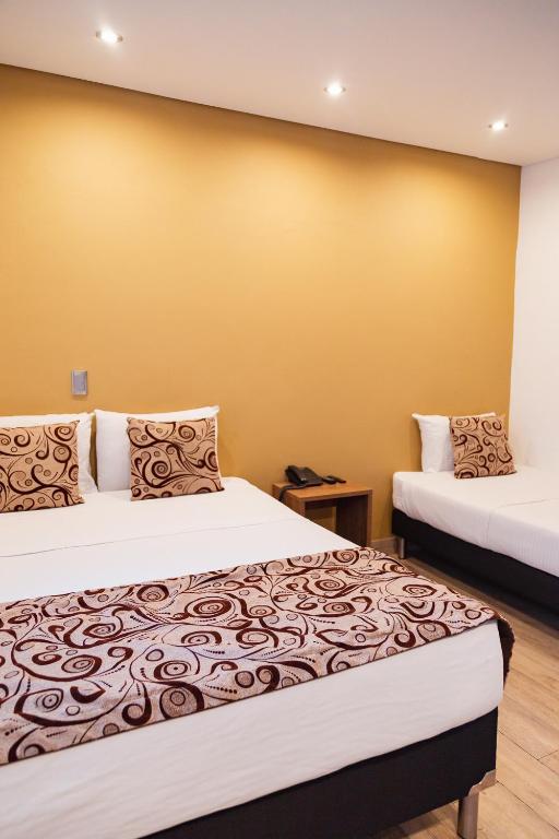 Postel nebo postele na pokoji v ubytování Hotel Laureles Loft