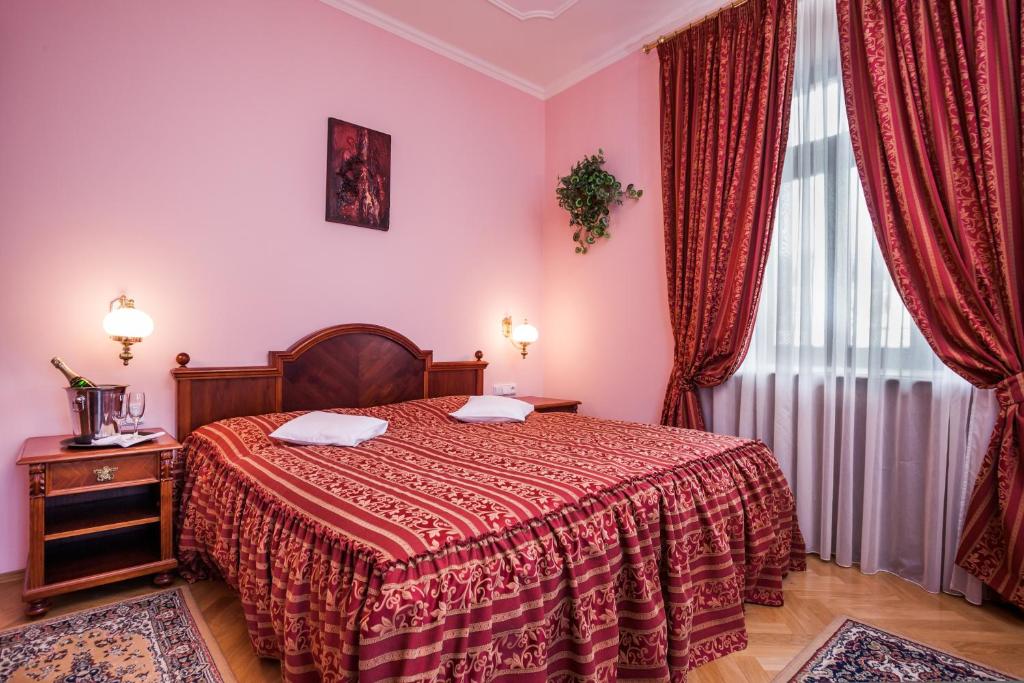 Postel nebo postele na pokoji v ubytování Hotel Jelínkova vila