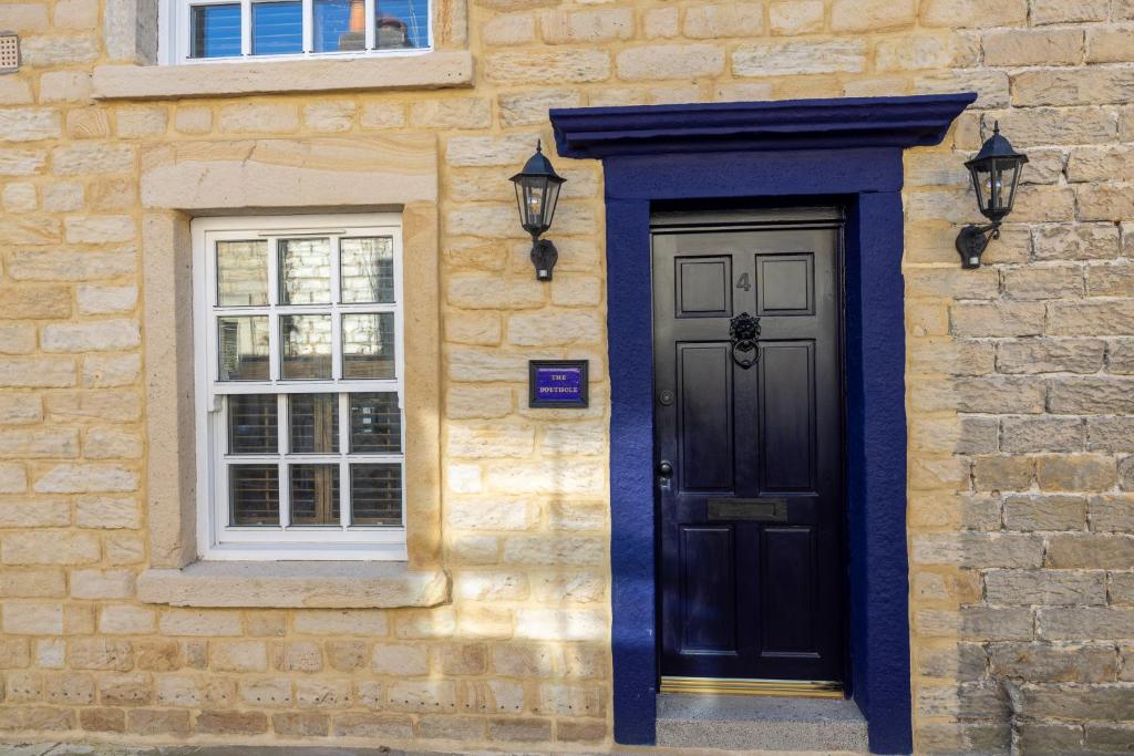 a black door and a window on a building at The Bolt Hole in Morecambe