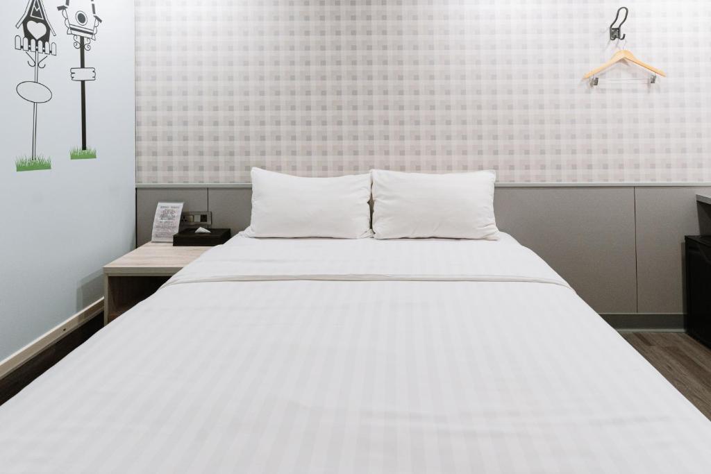 Postel nebo postele na pokoji v ubytování 歐法行旅 O Fun Hotel