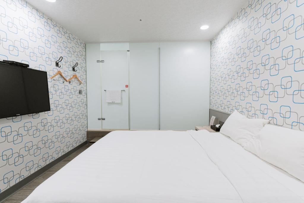 Postel nebo postele na pokoji v ubytování 歐法行旅 O Fun Hotel