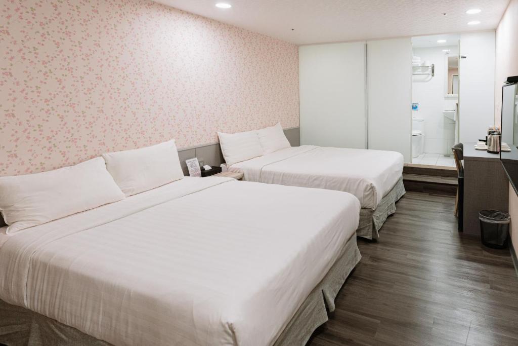 Postel nebo postele na pokoji v ubytování 歐法行旅 O Fun Hotel