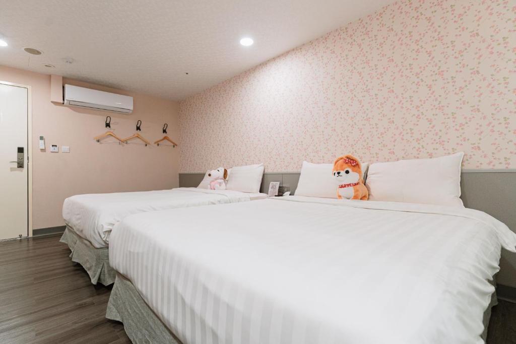 Postel nebo postele na pokoji v ubytování 歐法行旅 O Fun Hotel