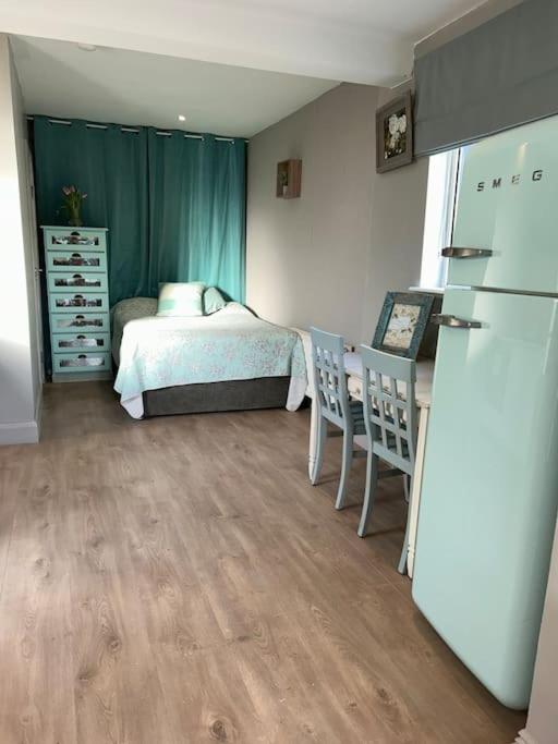 a small bedroom with a bed and a refrigerator at Guest Suite in Glenageary in Dublin