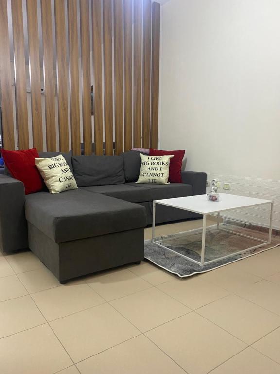 a couch and a coffee table in a room at Chlo apartment 4 Tirane in Tirana