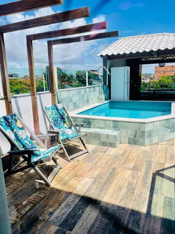 a pair of chairs sitting on a deck next to a swimming pool at Villa Prado in Prado