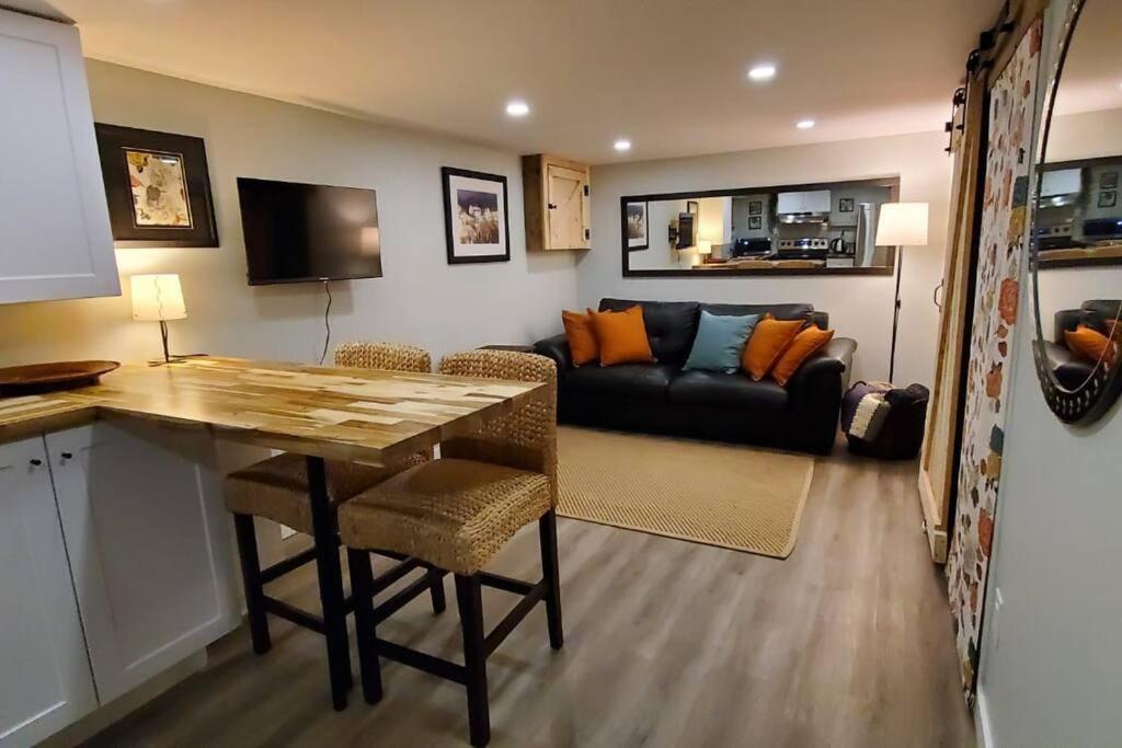 a living room with a table and a couch at 1 bedroom basement apartment with free parking in Brampton