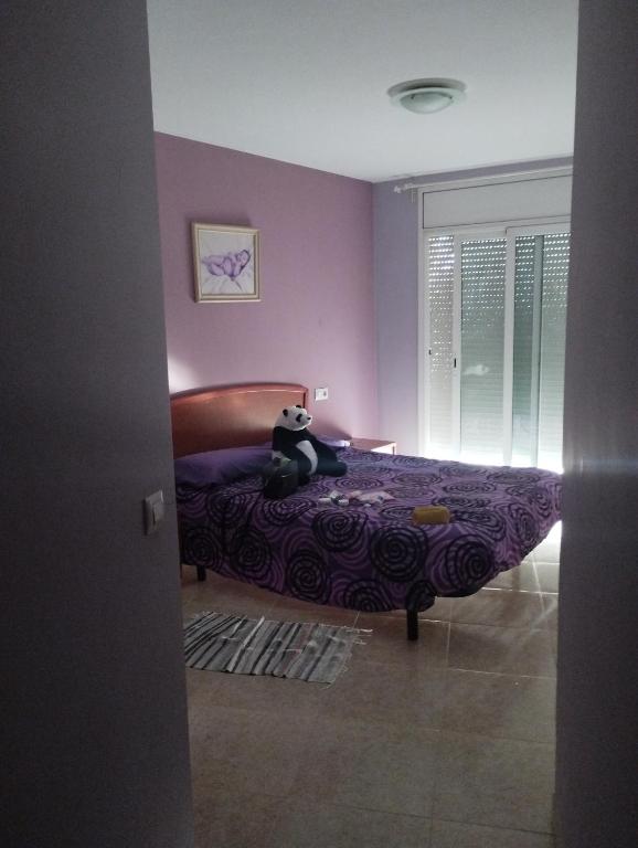 a bedroom with a bed with a cat sitting on it at Apartamento palafolls in Palafolls