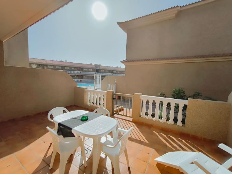 a balcony with a white table and white chairs at Poris puesta de sol 2 in Santa Cruz de Tenerife