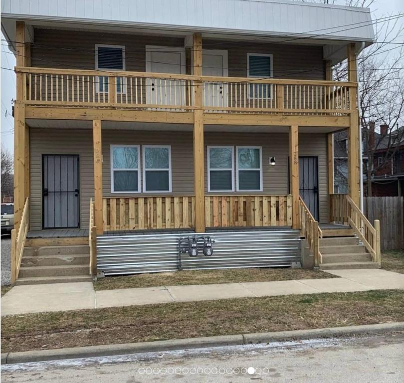a house with a large deck on top of it at Housepitality - The Urban Roost 2 - Location in Columbus