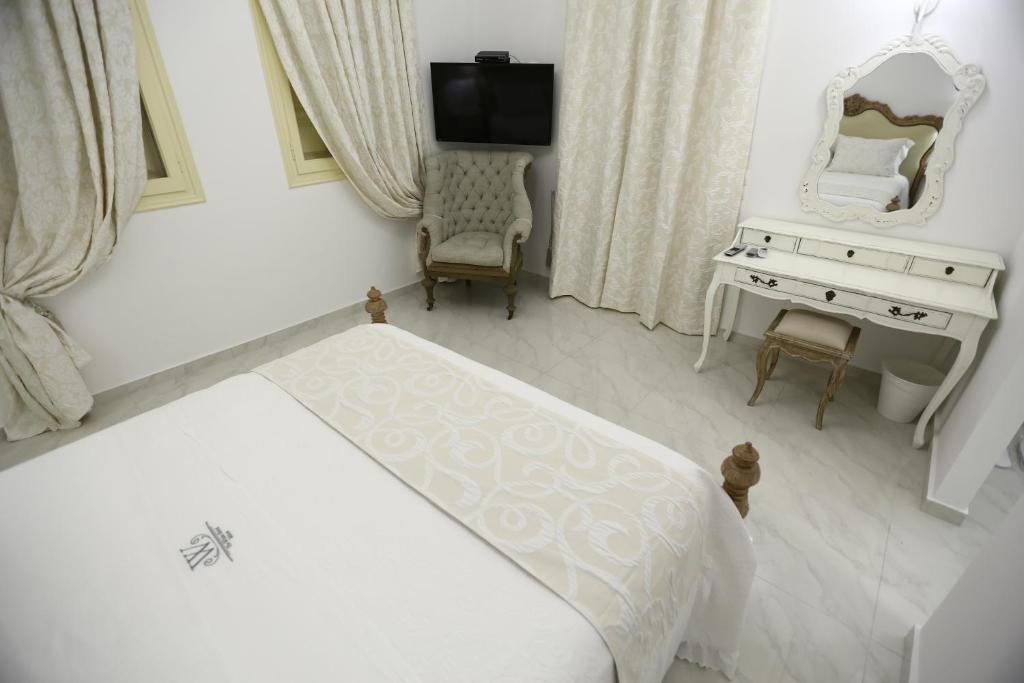 Posteľ alebo postele v izbe v ubytovaní The White Suites