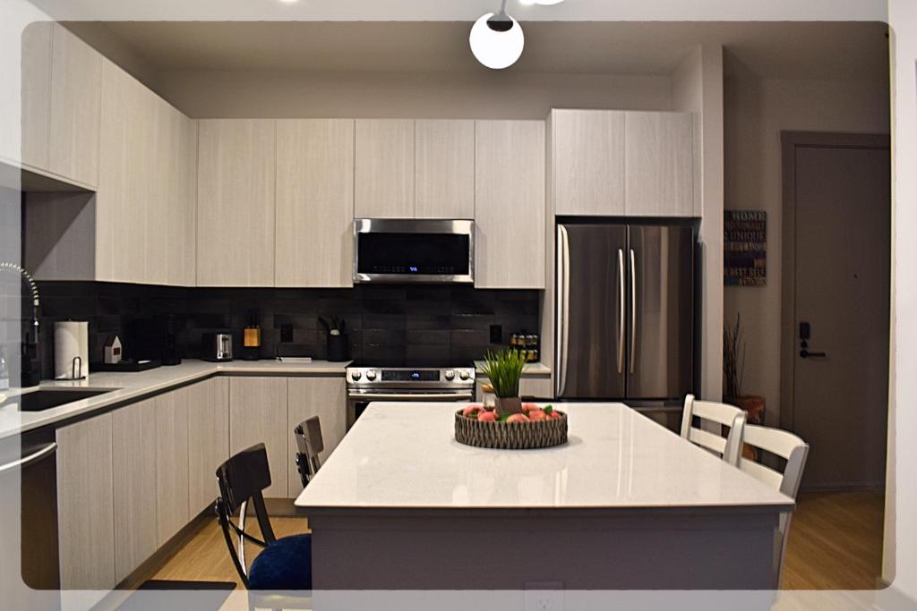 a kitchen with a table with a bowl of fruit on it at Atlanta at The Interlock Lux Escape in Atlanta