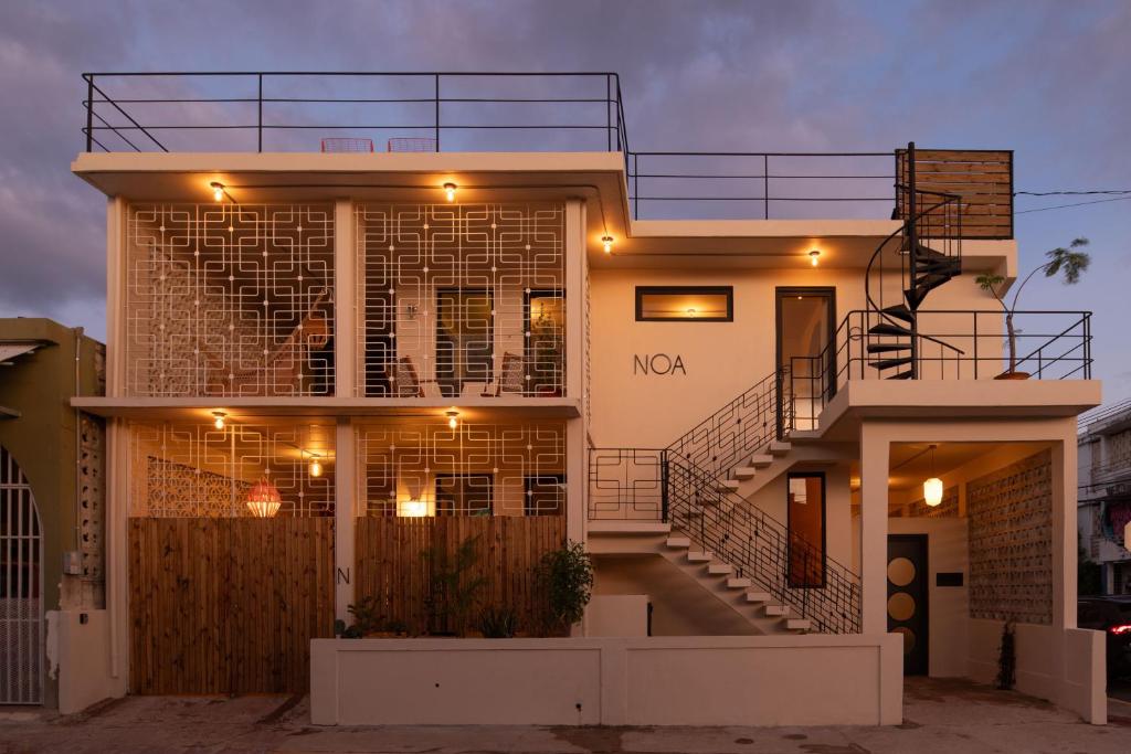 a house with lights on the front of it at NOA by DW in San Juan