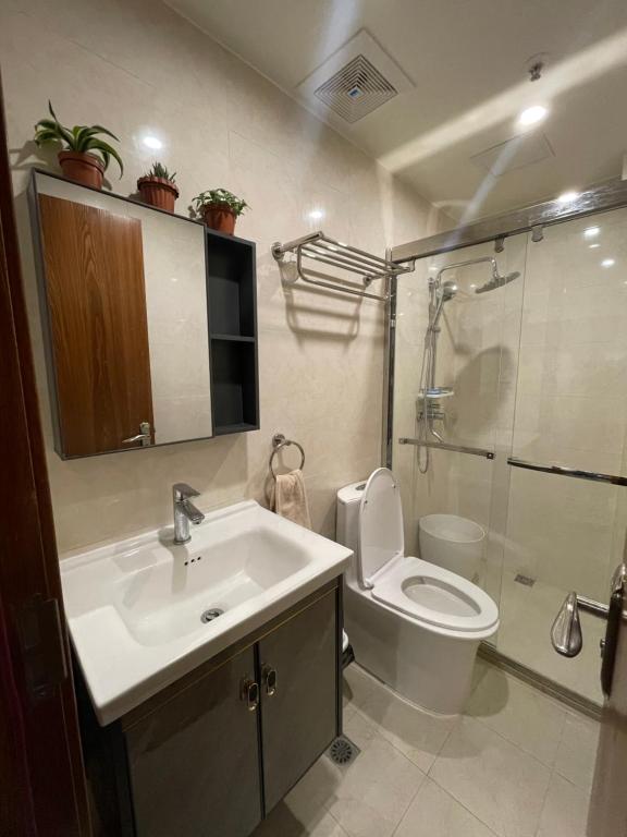 a bathroom with a sink and a toilet and a shower at CASA JBL Megatower 4 in Baguio