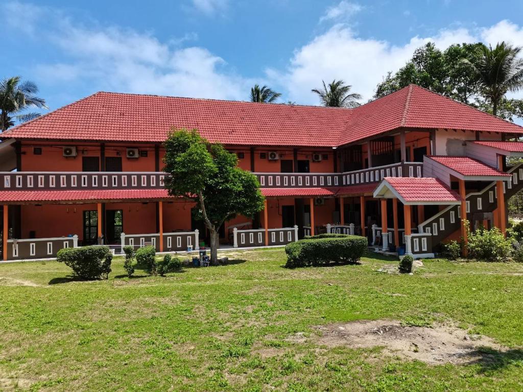 a large house with a red roof at Matahari Chalet Long Beach Perhentian Island in Perhentian Islands
