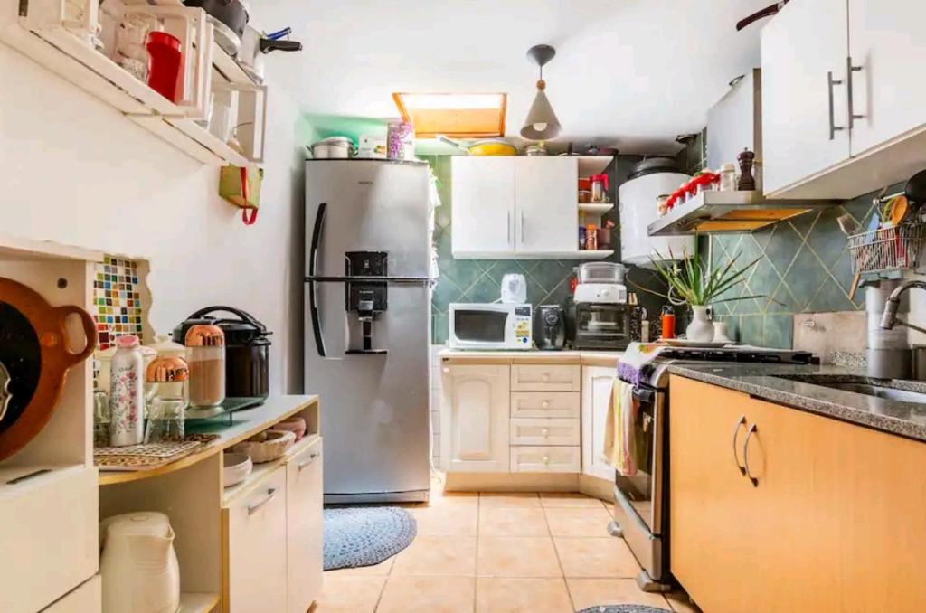 a kitchen with a stainless steel refrigerator at Oasis casa da melody in Munro