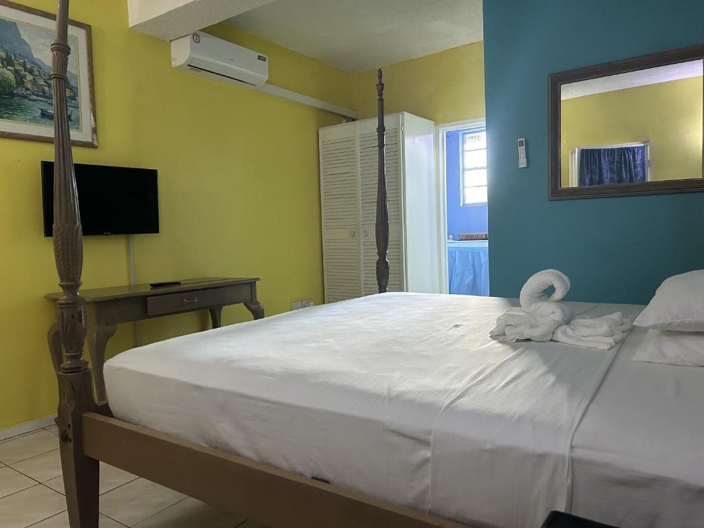 a bedroom with a bed with a stuffed animal on it at Bay Heights Escape in Gros Islet