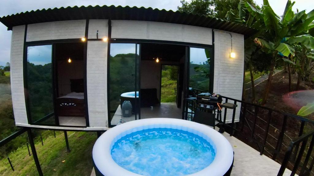 a bath tub in front of a small house at Glamping Moterio in Santa Rosa de Cabal