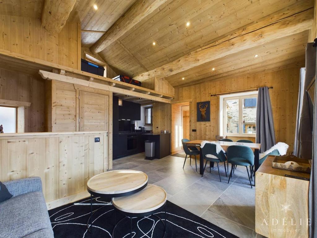 a living room with wooden walls and a table and chairs at Appartement Montvalezan-La Rosière, 6 pièces, 6 personnes - FR-1-398-662 in Montvalezan