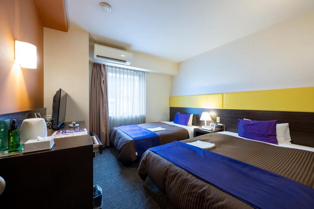 Postel nebo postele na pokoji v ubytování Hotel 1-2-3 Takasaki