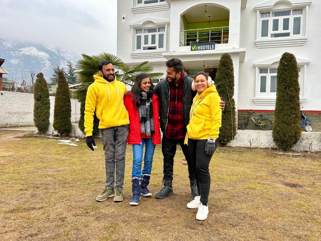 a group of people standing in front of a house at Whostels Srinagar in Srinagar