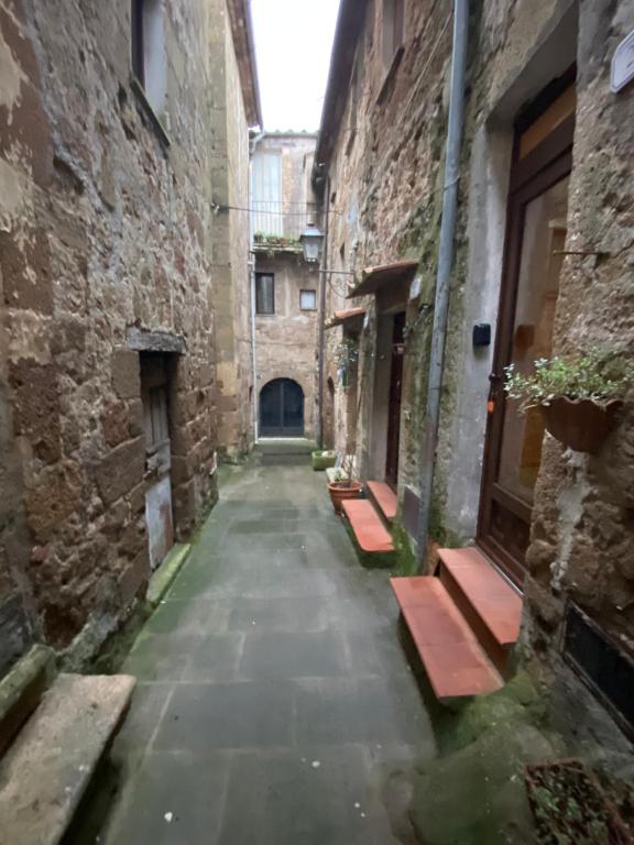 an alley with benches in an old building at Casa Della Rosa in Pitigliano