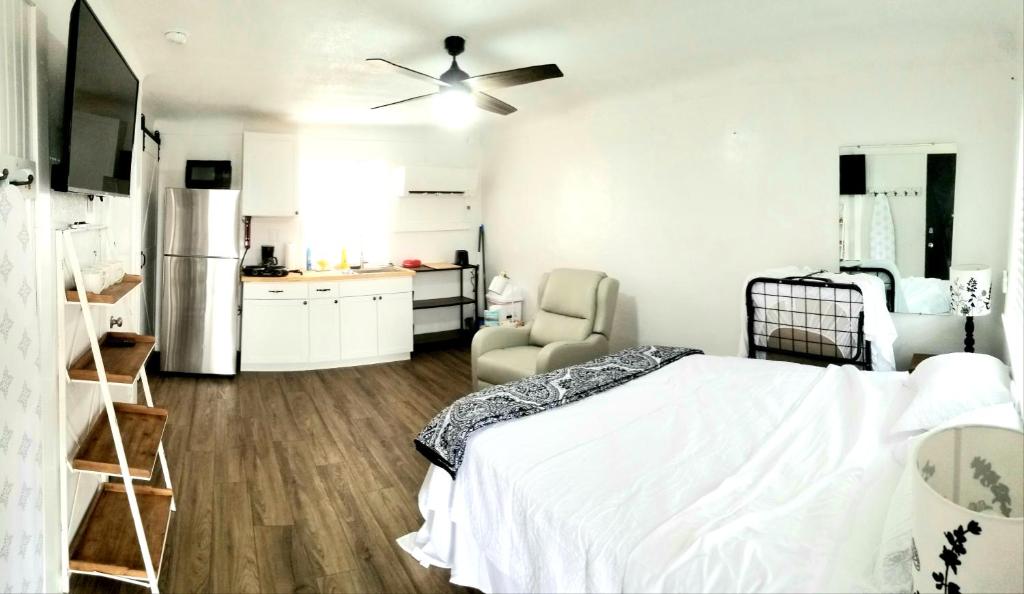 um quarto branco com uma cama e uma ventoinha de tecto em Lakeview Luxury Resort em Lakeview