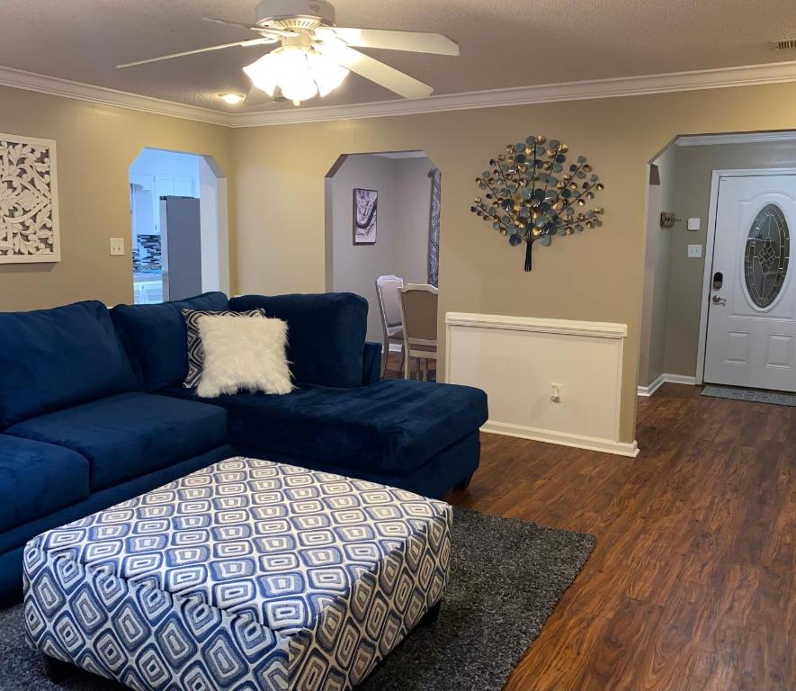 a living room with a blue couch and a table at Welcome to Cozy and Quiet Residence in Valdosta