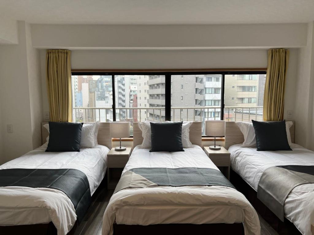 Postel nebo postele na pokoji v ubytování Le Tour Hotel Akihabara Kanda 楽途ホテル神田秋葉原