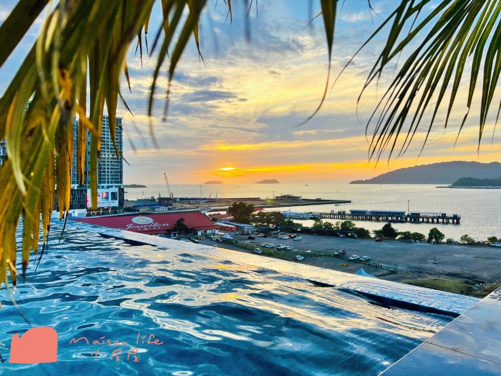 a swimming pool with a view of the ocean at Maison life 小居屋 Jesselton Quay CityPads in Kota Kinabalu