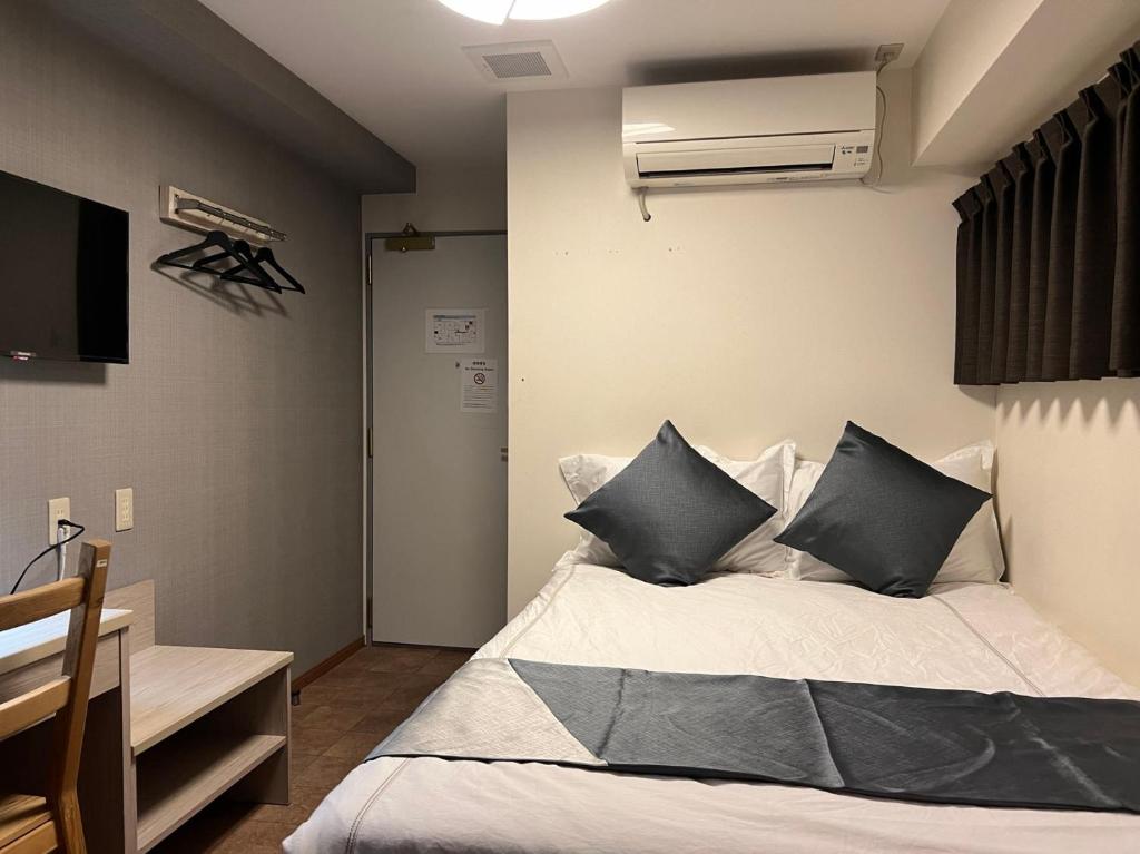 Postel nebo postele na pokoji v ubytování Le Tour Hotel Akihabara Kanda 楽途ホテル神田秋葉原