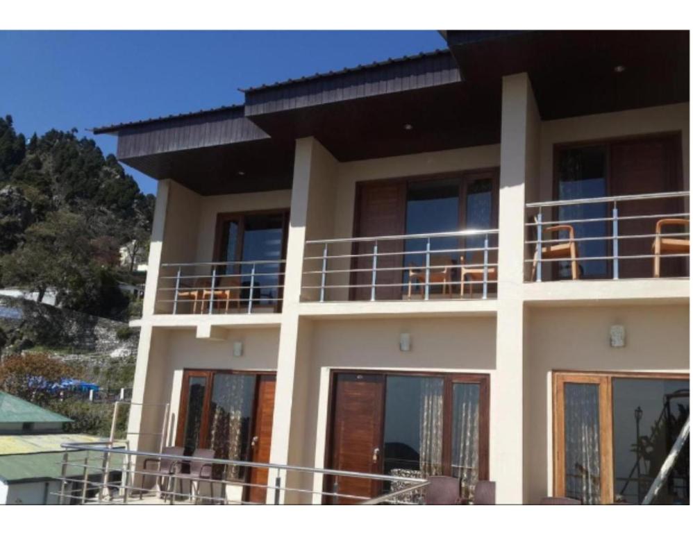 a building with balconies on the side of it at Hotel Valley View, Mussoorie in Mussoorie