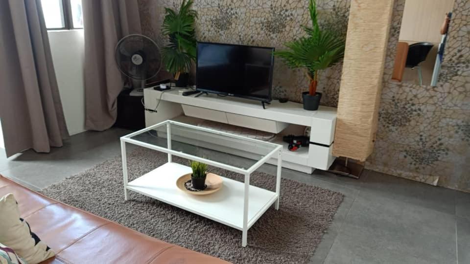 a living room with a tv and a white coffee table at 214 Nana's Homes Netflix n WiFi in Petaling Jaya