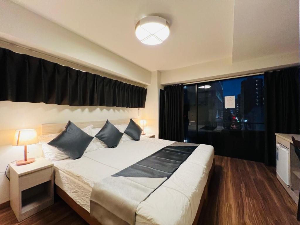 Postel nebo postele na pokoji v ubytování Le Tour Hotel Akihabara Kanda 楽途ホテル神田秋葉原