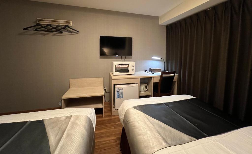 Postel nebo postele na pokoji v ubytování Le Tour Hotel Akihabara Kanda 楽途ホテル神田秋葉原