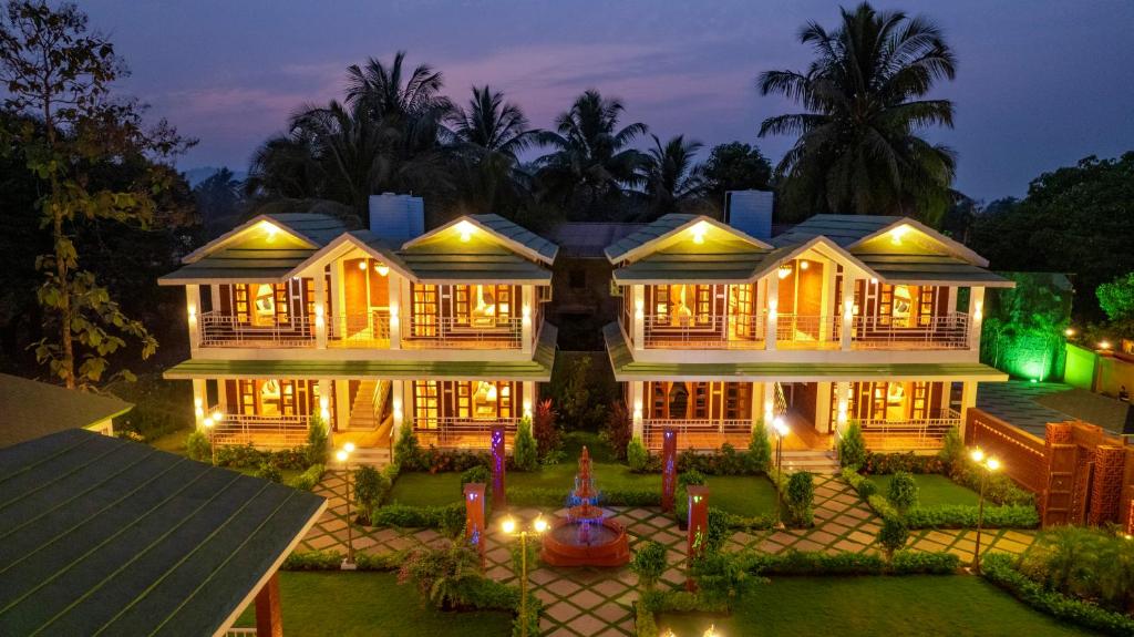 an image of a house at night with lights at Coconut Greenland Resort in Nagaon