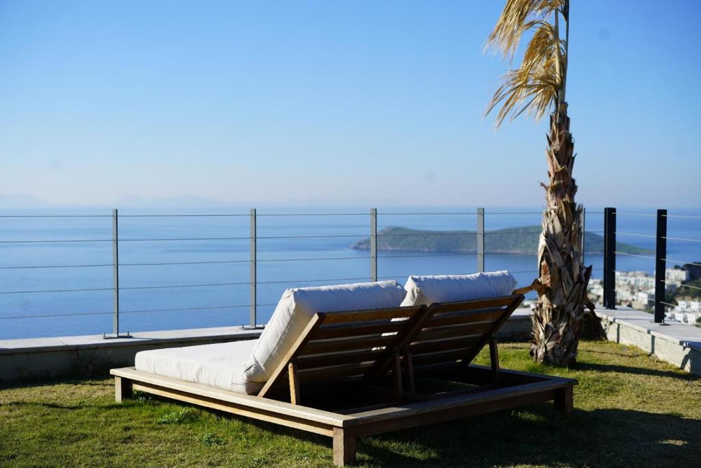 a chaise lounger sitting next to a palm tree at Fuga Panorama in Bodrum City