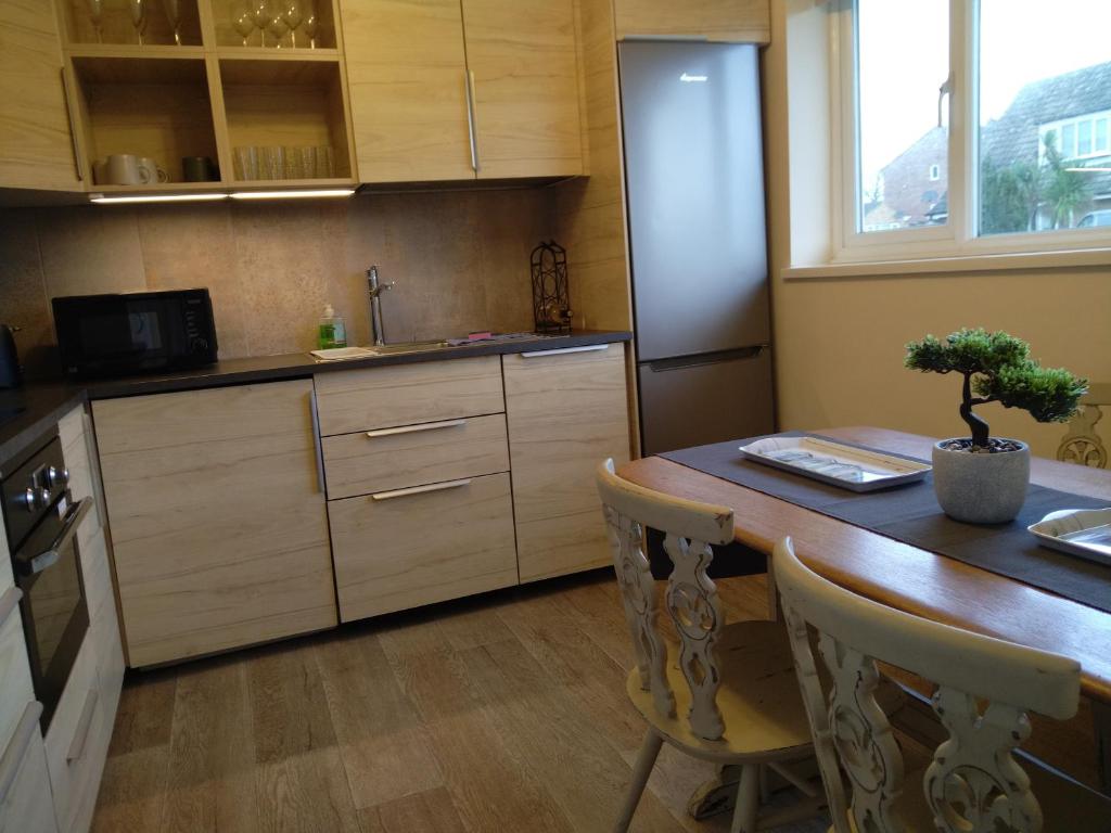 a kitchen with a wooden table with a plant on it at Beautiful 3-Bed Bungalow Kessingland rural retreat in Lowestoft