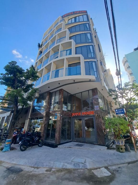 a building with a motorcycle parked in front of it at JOYCE HOUSE in Quy Nhon