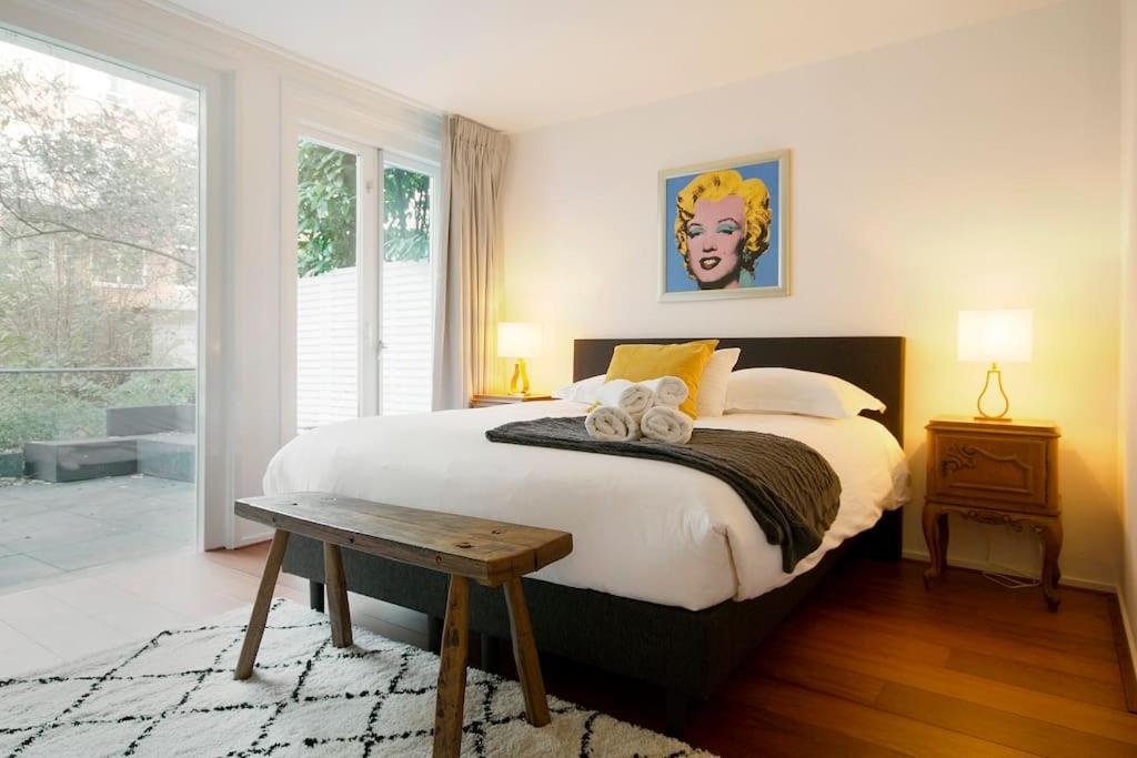 um quarto com uma cama grande e uma mesa em NEW 4p renovated apartment @BEST location Jordaan em Amsterdã