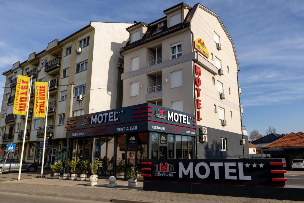 a hotel building with a motel sign in front of it at Motel Milošević in Bijeljina