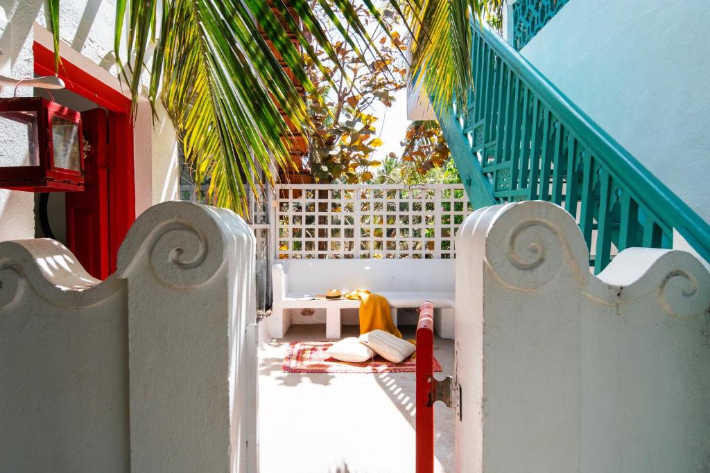 a balcony with a gate and a table and a palm tree at The Secret Cove by Stay ALYF, Baga in Baga
