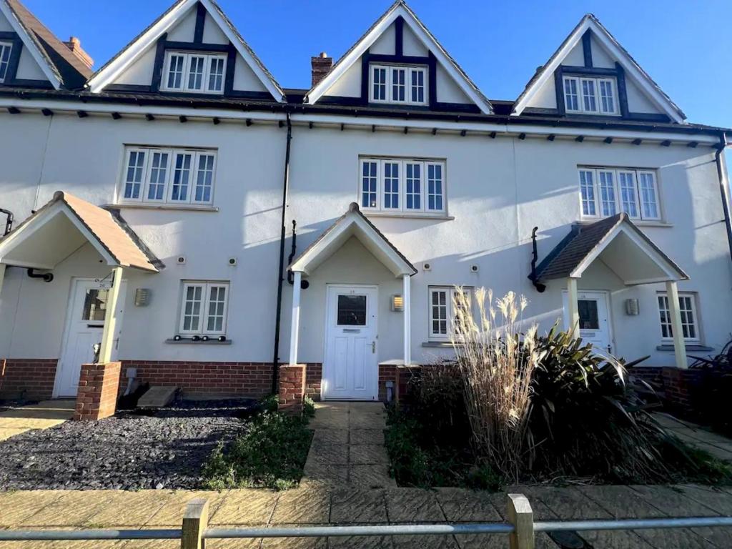 a white house with a lot of windows at Pass the Keys 3 Bed home away from home in Colchester