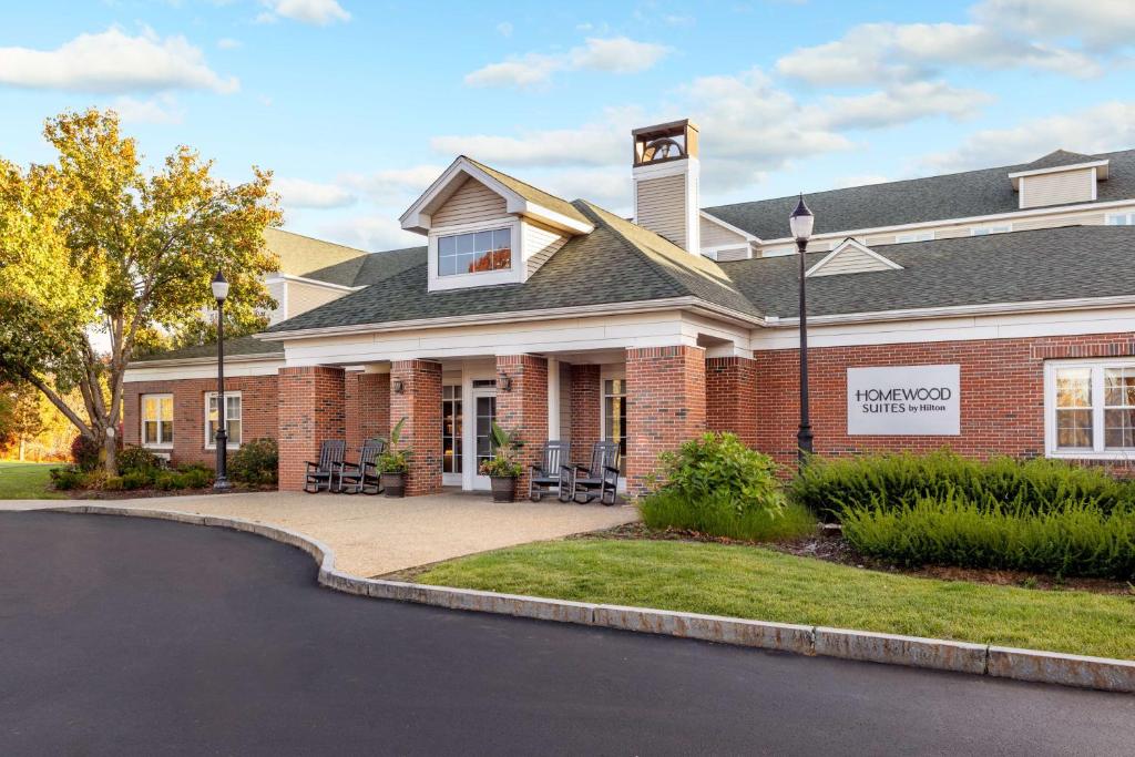 a house with a driveway in front of it at Homewood Suites by Hilton Manchester/Airport in Manchester